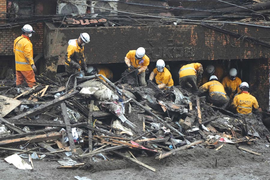 Japan searches for dozens missing in resort town mudslide