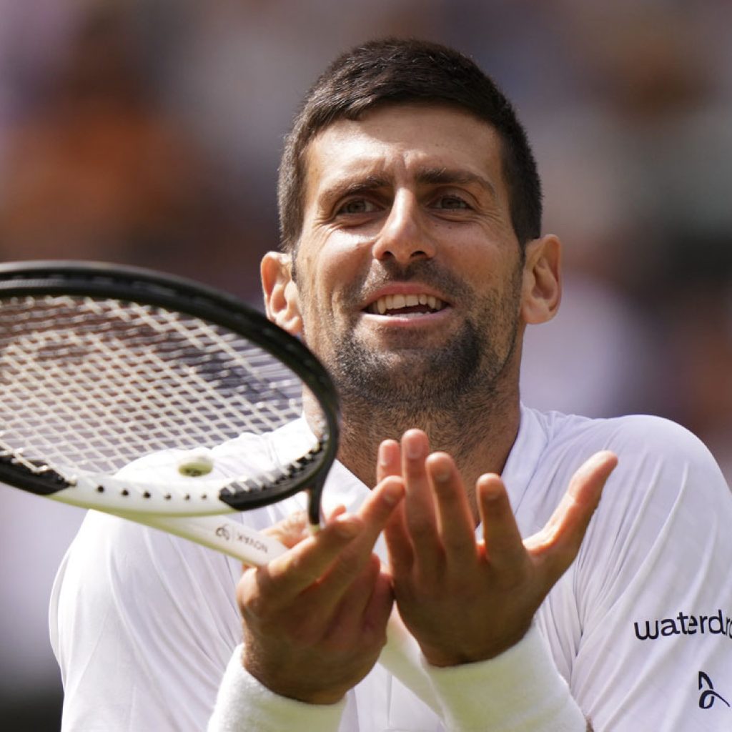Novak Djokovic reacts as he plays Poland's Hubert Hurkacz in a men's singles match on day eight of the Wimbledon tennis championships in London