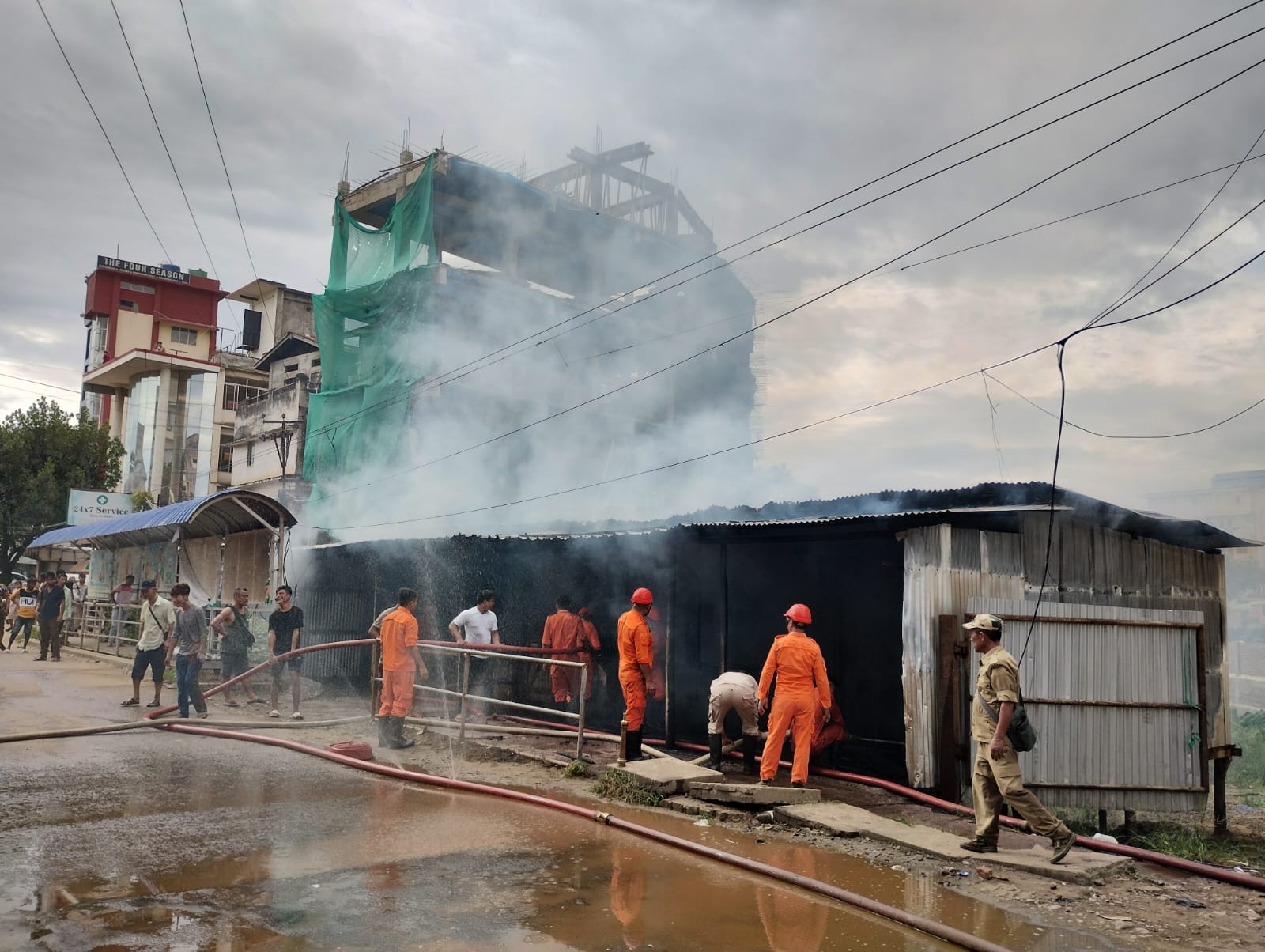 Firefighters tackling a massive blaze at Nagarjan Traffic Junction, Dimapur.