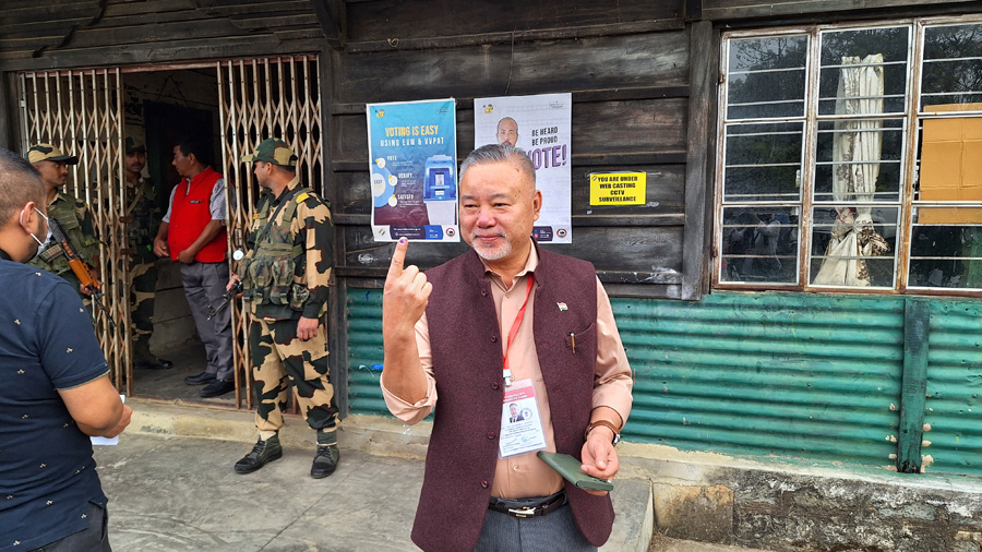 Dr. Chumben Murry shows his finger marked with indelible ink after casting his vote in Wokha town on Friday.