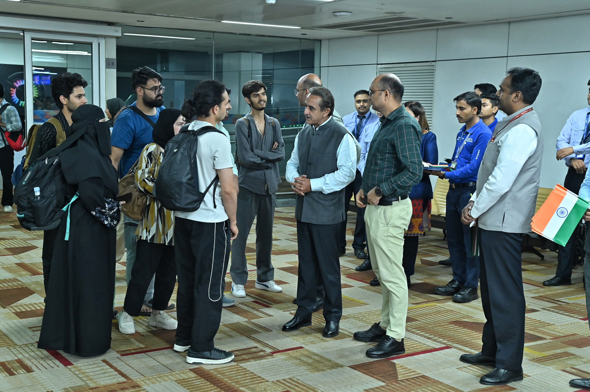 In this image released by @KVSinghMPGonda via X on June 19, 2025, Minister of State for External Affairs Kirti Vardhan Singh meets the Indian students returning from war-torn Iran via Armenia, under an evacuation operation facilitated by the Indian government, at Indira Gandhi International Airport in New Delhi.